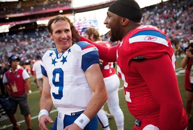 HONOLULU - JANUARY 30:  Drew Brees, #9 of the New Orleans Saints, shares a laugh with Devin McCourty, #32 of the New England Patriots, after the 2011 NFL Pro Bowl at Aloha Stadium on January 30, 2011 in Honolulu, Hawaii. NFC won 55-41 over the AFC. (Photo by Kent Nishimura/Getty Images)