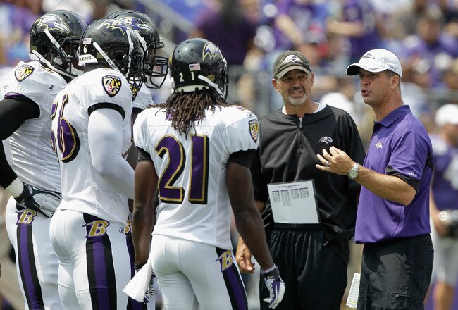 BALTIMORE, MD - AUGUST 06: Baltimore Ravens head coach John Harbaugh (R) and defensive coordinator Chuck Pagano (C) talk with the defense during training camp at M&T Bank Stadium on August 6, 2011 in Baltimore, Maryland.  (Photo by Rob Carr/Getty Images)