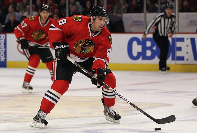 CHICAGO, IL - JANUARY 12:  Nick Leddy #8 of the Chicago Blackhawks controls the puck against the Minnesota Wild at the United Center on January 12, 2012 in Chicago, Illinois. The Blackhawks defeated the Wild 5-2.  (Photo by Jonathan Daniel/Getty Images)