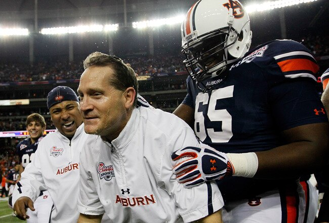 ATLANTA, GA - DECEMBER 31:  Head coach Gene Chizik of the Auburn Tigers celebrates after their 43-24 win over the Virginia Cavaliers with Tunde Fariyike #65 and Trooper Taylor during the 2011 Chick Fil-A Bowl at Georgia Dome on December 31, 2011 in Atlanta, Georgia.  (Photo by Kevin C. Cox/Getty Images)