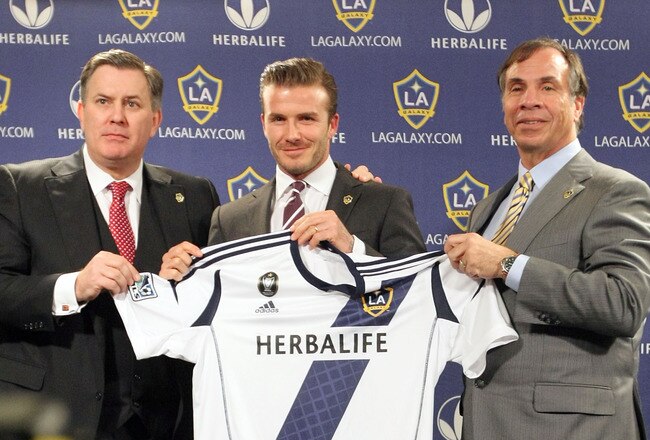 LOS ANGELES, CA - JANUARY 19:  (L-R) President of AEG Tim Leiweke, midfielder David Beckham of the Los Angeles Galaxy and Head Coach Bruce Arena of the Los Angeles Galaxy present Beckham with his new jersey during the press conference announcing David Beckham's new contract at Staples Center on January 19, 2012 in Los Angeles, California.  (Photo by Victor Decolongon/Getty Images)