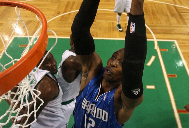 BOSTON - MAY 28:  Dwight Howard #12 of the Orlando Magic dunks against the Boston Celtics in Game Six of the Eastern Conference Finals during the 2010 NBA Playoffs at TD Garden on May 28, 2010 in Boston, Massachusetts.  NOTE TO USER: User expressly acknowledges and agrees that, by downloading and/or using this Photograph, user is consenting to the terms and conditions of the Getty Images License Agreement.  (Photo by Winslow Townsow-Pool/Getty Images)