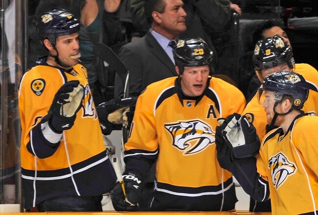 NASHVILLE, TN - JANUARY 07:  Ryan Ellis #49 of the Nashville Predators is congratulated by teammates Shea Weber #6 and Ryan Suter #20 on scoring his first career NHL goal against the Carolina Hurricanes at the Bridgestone Arena on January 7, 2012 in Nashville, Tennessee.  (Photo by Frederick Breedon/Getty Images)