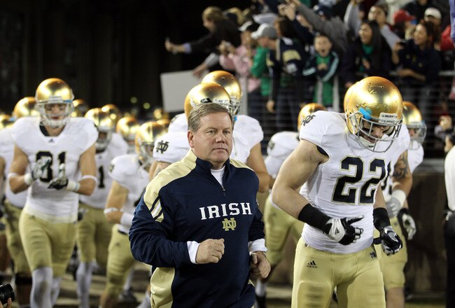 STANFORD, CA - NOVEMBER 26:  Notre Dame Fighting Irish head coach Brian Kelly run on to the field for their game against the Stanford Cardinal at Stanford Stadium on November 26, 2011 in Stanford, California.  (Photo by Ezra Shaw/Getty Images)
