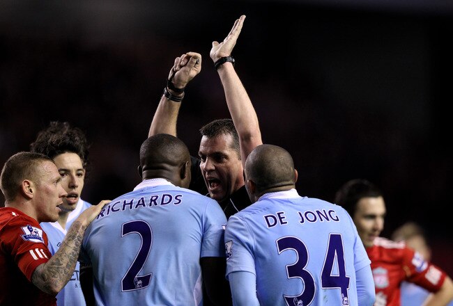 LIVERPOOL, ENGLAND - JANUARY 25:  Micah Richards of Manchester City protests to  Referee Phil Dowd after he awarded a penalty during the Carling Cup Semi Final Second Leg match between Liverpool and Manchester City at Anfield on January 25, 2012 in Liverpool, England.  (Photo by Alex Livesey/Getty Images)