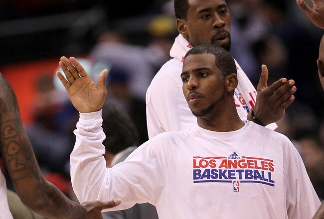 LOS ANGELES, CA - JANUARY 04:  Chris Paul #3 of the Los Angeles Clippers celebrates with teammates after the game with the Houston Rockets at Staples Center on January 4, 2012 in Los Angeles, California.  The Clippers won 117-89.  NOTE TO USER: User expressly acknowledges and agrees that, by downloading and or using this photograph, User is consenting to the terms and conditions of the Getty Images License Agreement.  (Photo by Stephen Dunn/Getty Images)