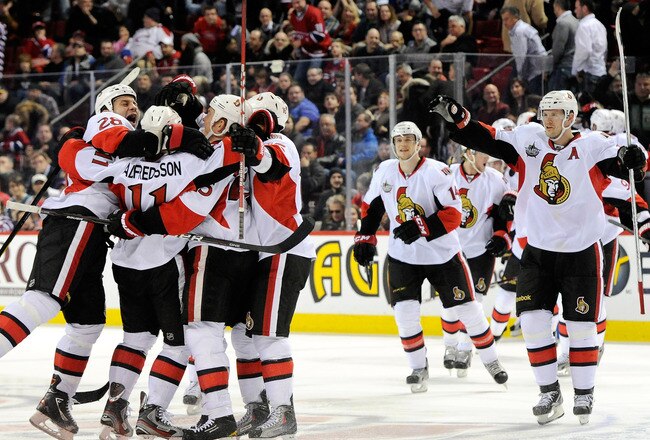 MONTREAL, CANADA - JANUARY 14:  Members of the Ottawa Senators celebrate the game winning goal by teammate Daniel Alfredsson #11 during the NHL game against the Montreal Canadiens at the Bell Centre on January 14, 2012 in Montreal, Quebec, Canada.  The Senators defeated the Canadiens 3-2 in a shootout.  (Photo by Richard Wolowicz/Getty Images)