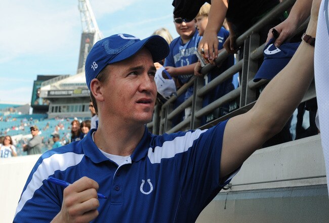 JACKSONVILLE, FL - JANUARY 01: Quarterback Peyton Manning #18 of the Indianapolis Colts signs autographs before the kickoff against the Jacksonville Jaguars January 1 at EverBank Field in Jacksonville, Florida.  (Photo by Al Messerschmidt/Getty Images)