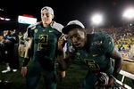 PASADENA, CA - JANUARY 02:  (L-R) Bryan Bennett #2 and Darron Thomas #5 of the Oregon Ducks celebrate the Ducks 45-38 victory against the Wisconsin Badgers at the 98th Rose Bowl Game on January 2, 2012 in Pasadena, California.  (Photo by Jeff Gross/Getty Images)
