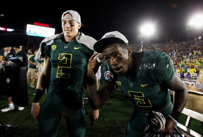 PASADENA, CA - JANUARY 02:  (L-R) Bryan Bennett #2 and Darron Thomas #5 of the Oregon Ducks celebrate the Ducks 45-38 victory against the Wisconsin Badgers at the 98th Rose Bowl Game on January 2, 2012 in Pasadena, California.  (Photo by Jeff Gross/Getty Images)