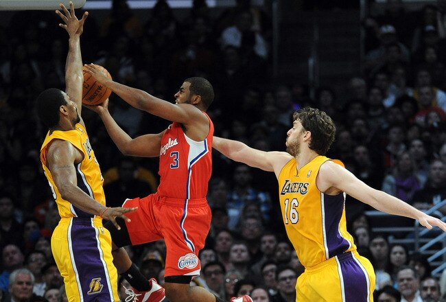 LOS ANGELES, CA - DECEMBER 19:  Chris Paul #3 of the Los Angeles Clippers drives to the basket on Metta World Peace #15 and Pau Gasol #16 of the Los Angeles Lakers at Staples Center on December 19, 2011 in Los Angeles, California.  The Clippers beat the Lakers 114-95.  (Photo by Harry How/Getty Images)