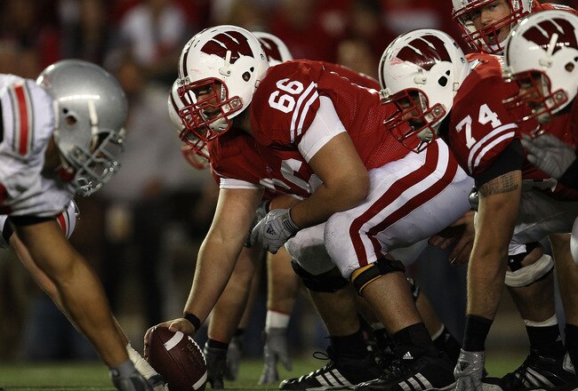 MADISON, WI - OCTOBER 16: Peter Konz #66 of the Wisconsin Badgers prepares to snap the ball to Scott Tolzien #16 against the Ohio State Buckeyes at Camp Randall Stadium on October 16, 2010 in Madison, Wisconsin. Wisconsin defeated Ohio State 31-18.  (Photo by Jonathan Daniel/Getty Images)
