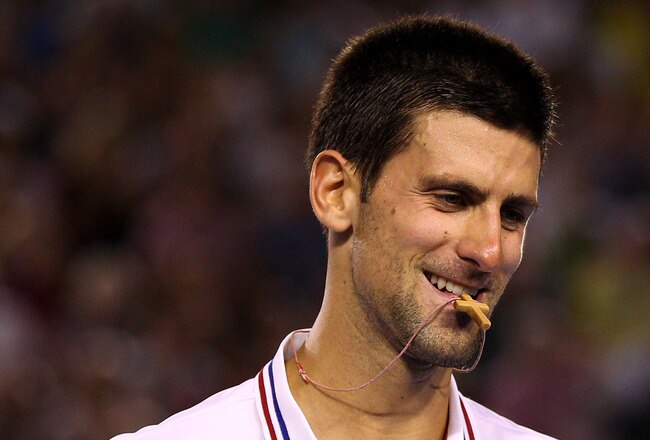 MELBOURNE, AUSTRALIA - JANUARY 27:  Novak Djokovic of Serbia smiles after winning match point in his semifinal match against Andy Murray of Great Britain during day twelve of the 2012 Australian Open at Melbourne Park on January 27, 2012 in Melbourne, Australia.  (Photo by Cameron Spencer/Getty Images)