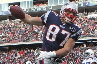 FOXBORO, MA - DECEMBER 4:   Rob Gronkowski #87 of the New England Patriots beats  A.J. Edds #52 of the Indianapolis Colts for his third touch during the second half at Gillette Stadium on December 4, 2011 in Foxboro, Massachusetts. (Photo by Jim Rogash/Getty Images)