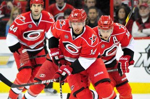 RALEIGH, NC - JANUARY 14:  Andreas Nodl #14 of the Carolina Hurricanes leads the rush up the ice against the Boston Bruins during play at the RBC Center on January 14, 2012 in Raleigh, North Carolina.  (Photo by Grant Halverson/Getty Images)