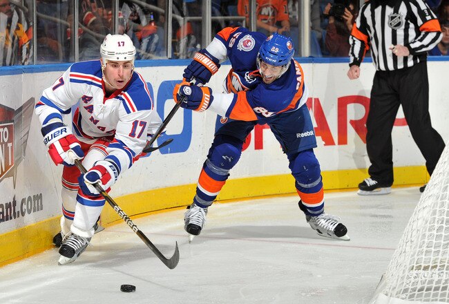 UNIONDALE, NY - NOVEMBER 15: Brandon Dubinsky #17 of the New York Rangers is challenged for the puck by Jay Pandolfo #29 of the New York Islanders during the third period at Nassau Coliseum on November 15, 2011 in Uniondale, New York. (Photo by Christopher Pasatieri/Getty Images)