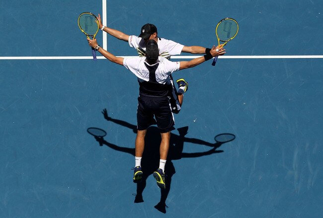 MELBOURNE, AUSTRALIA - JANUARY 26:  Bob Bryan  and Mike Bryan of the United States of America chest bump in celebration of winning their doubles semifinal match against Horia Tecau of Romania and Robert Lindstedt of Sweden during day eleven of the 2012 Australian Open at Melbourne Park on January 26, 2012 in Melbourne, Australia.  (Photo by Ryan Pierse/Getty Images)