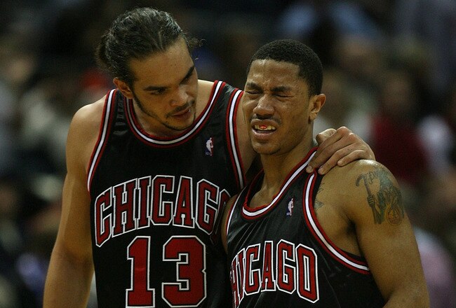 MILWAUKEE - NOVEMBER 30: Joakim Noah #13 of the Chicago Bulls consoles teammate Derrick Rose #1 during a time-out after Rose was fouled during a game against the Milwaukee Bucks at the Bradley Center on November 30, 2009 in Milwaukee, Wisconsin. The Bucks defeated the Bulls 99-97. NOTE TO USER: User expressly acknowledges and agrees that, by downloading and/or using this Photograph, User is consenting to the terms and conditions of the Getty Images License Agreement. (Photo by Jonathan Daniel/Getty Images)