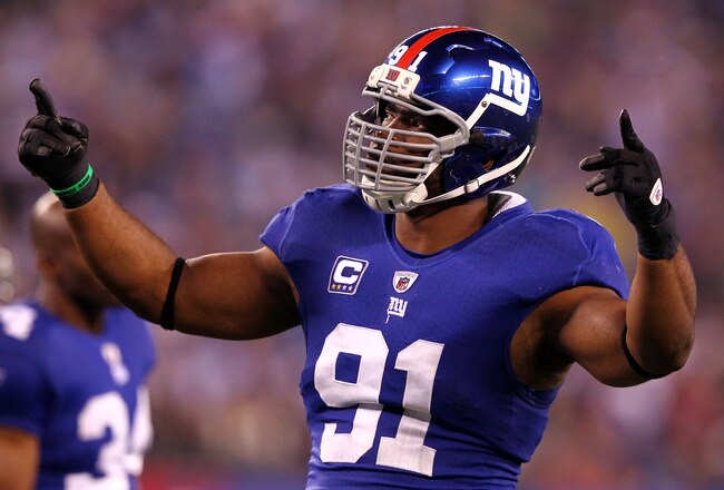 EAST RUTHERFORD, NJ - JANUARY 01:  Justin Tuck #91 of the New York Giants attempts to pump up the crowd against the Dallas Cowboys at MetLife Stadium on January 1, 2012 in East Rutherford, New Jersey.  (Photo by Al Bello/Getty Images)