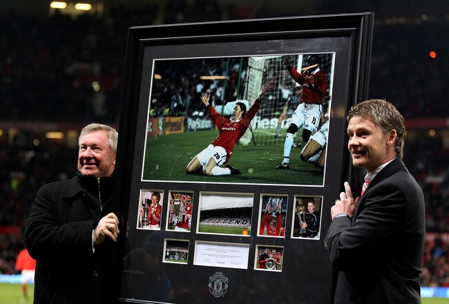 MANCHESTER, ENGLAND - DECEMBER 13:  Manchester United Manager Sir Alex Ferguson presents Ole Gunnar Solskjaer with a print of his winning goal celebration from the 1999 Champions League Final prior to the Barclays Premier League match between Manchester United and Arsenal at Old Trafford on December 13, 2010 in Manchester, England.  (Photo by Alex Livesey/Getty Images)