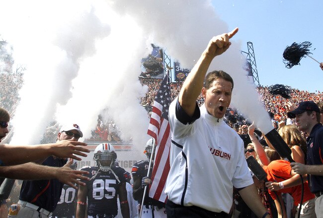 AUBURN, AL - SEPTEMBER 10:  Coach Gene Chizik of the Auburn Tigers leads the team onto the field to start the game against the Mississippi State Bulldogs on September 10, 2011 at Jordan-Hare Stadium in Auburn, Alabama. (Photo by Butch Dill/Getty Images)