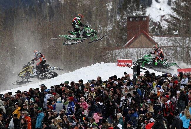 ASPEN, CO - JANUARY 30:  Spectators pack together next to the course as competitors criss cross the course during an elimination round in the Snowmobile SnoCross during Winter X Games 15 at Buttermilk Mountain on January 30, 2011 in Aspen, Colorado.  (Photo by Doug Pensinger/Getty Images)