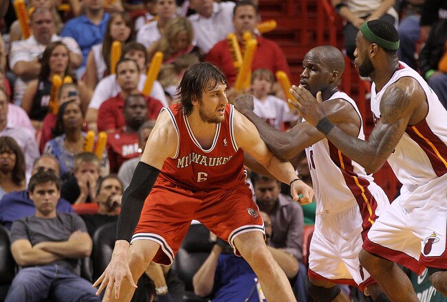 MIAMI, FL - APRIL 06:  Andrew Bogut #6 of the Milwaukee Bucks posts up  Joel Anthony #50 and LeBron James #6 of the Miami Heat during a game at American Airlines Arena on April 6, 2011 in Miami, Florida. NOTE TO USER: User expressly acknowledges and agrees that, by downloading and/or using this Photograph, User is consenting to the terms and conditions of the Getty Images License Agreement.  (Photo by Mike Ehrmann/Getty Images)