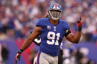 EAST RUTHERFORD, NJ - JANUARY 08:  Justin Tuck #91 of the New York Giants reacts against the Atlanta Falcons during their NFC Wild Card Playoff game at MetLife Stadium on January 8, 2012 in East Rutherford, New Jersey.  (Photo by Al Bello/Getty Images)