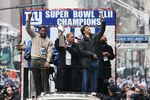 NEW YORK - FEBRUARY 05:  (L-R) Michael Strahan, Owner John Mara and Eli Manning of the New York Giants ride in a float along Broadway, also known as 'The Canyon of Heroes' during Super Bowl XLII victory parade in New York City.  (Photo by Al Bello/Getty Images)
