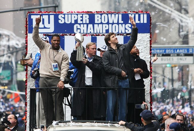NEW YORK - FEBRUARY 05:  (L-R) Michael Strahan, Owner John Mara and Eli Manning of the New York Giants ride in a float along Broadway, also known as 'The Canyon of Heroes' during Super Bowl XLII victory parade in New York City.  (Photo by Al Bello/Getty Images)