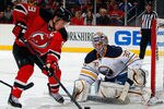 NEWARK, NJ - JANUARY 24:  Goalie Ryan Miller #30 of the Buffalo Sabres makes a save on a shot by Zach Parise #9 of the New Jersey Devils during the second period of an NHL hockey game at Prudential Center on January 24, 2012 in Newark, New Jersey.  (Photo by Paul Bereswill/Getty Images)