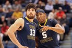 HARTFORD, CT - JANUARY 9:  Deniz Kilicli #13 of the West Virginia Mountaineers chats with Kevin Jones #5 of the West Virginia Mountaineers against the Connecticut Huskies at the XL Center on January 9, 2012,  in Hartford, Connecticut.  (Photo by Jim Rogash/Getty Images)