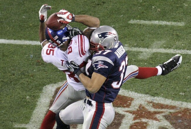GLENDALE, AZ - FEBRUARY 03:  David Tyree #85 of the New York Giants catches a 32-yard pass from Eli Manning #10 as Rodney Harrison #37 of the New England Patriots attempts to knock it out in the fourth quarter of Super Bowl XLII on February 3, 2008 at the University of Phoenix Stadium in Glendale, Arizona. The Giants defeated the Patriots 17-14.  (Photo by Doug Pensinger/Getty Images)