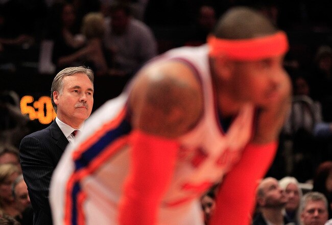 NEW YORK, NY - MARCH 30: Head coach Mike D'Antoni looks on over his player Carmelo Anthony #7 of the New York Knicks during the game against the New Jersey Nets at Madison Square Garden on March 30, 2011 in New York City. NOTE TO USER: User expressly acknowledges and agrees that, by downloading and/or using this Photograph, User is consenting to the terms and conditions of the Getty Images License Agreement. Then Knicks defeated the Nets 120-116.  (Photo by Chris Trotman/Getty Images)