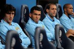 BOLTON, ENGLAND - AUGUST 21:  Carlos Tevez of Manchester City (2nd on L) watches from the bench during the Barclays Premier League match between Bolton Wanderers and Manchester City at the Reebok Stadium on August 21, 2011 in Bolton, England.  (Photo by Michael Regan/Getty Images)