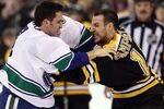 BOSTON, MA - JANUARY 07:  Maxim Lapierre #40 of the Vancouver Canucks and Gregory Campbell #11 of the Boston Bruins fight on January 7, 2012 at TD Garden in Boston, Massachusetts.  (Photo by Elsa/Getty Images)