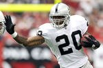GLENDALE, AZ - SEPTEMBER 26:  Runningback Darren McFadden #20 of the Oakland Raiders rushes the football past Paris Lenon #51 of the Arizona Cardinals during the first quarter of the NFL game at the University of Phoenix Stadium on September 26, 2010 in Glendale, Arizona. The Cardinals defeated the Raiders 24-23.  (Photo by Christian Petersen/Getty Images)