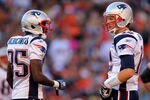 DENVER, CO - DECEMBER 18:  Wide receiver Chad Ochocinco #85 talks with quarterback Tom Brady #12 of the New England Patriots during a game against the Denver Broncos at Sports Authority Field at Mile High on December 18, 2011 in Denver, Colorado.  (Photo by Doug Pensinger/Getty Images)
