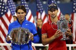 NEW YORK, NY - SEPTEMBER 12:  Novak Djokovic of Serbia holds up the winner's the trophy as Rafael Nadal (L) of Spain holds up the runner up award after Djokovic defeated Nadal during the Men's Final on Day Fifteen of the 2011 US Open at the USTA Billie Jean King National Tennis Center on September 12, 2011 in the Flushing neighborhood of the Queens borough of New York City.  (Photo by Clive Brunskill/Getty Images)