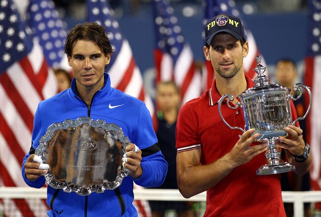 NEW YORK, NY - SEPTEMBER 12:  Novak Djokovic of Serbia holds up the winner's the trophy as Rafael Nadal (L) of Spain holds up the runner up award after Djokovic defeated Nadal during the Men's Final on Day Fifteen of the 2011 US Open at the USTA Billie Jean King National Tennis Center on September 12, 2011 in the Flushing neighborhood of the Queens borough of New York City.  (Photo by Clive Brunskill/Getty Images)