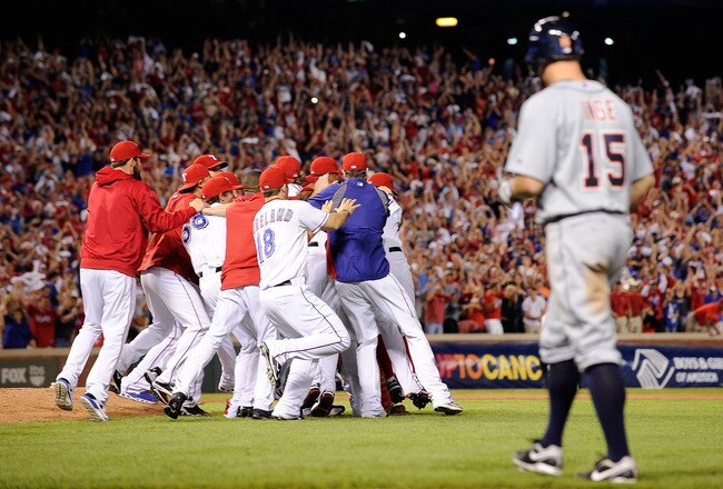 ARLINGTON, TX - OCTOBER 15:  Brandon Inge #15 of the Detroit Tigers walks off the field as the Texas Rangers celebrate winning Game Six of the American League Championship Series 15-5 against the Tigers to advance to the World Series at Rangers Ballpark in Arlington on October 15, 2011 in Arlington, Texas.  (Photo by Kevork Djansezian/Getty Images)