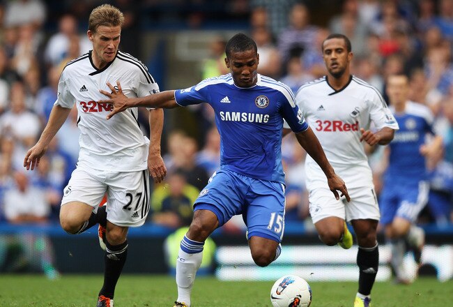 LONDON, ENGLAND - SEPTEMBER 24:  Florent Malouda of Chelsea holds off Mark Gower of Swansea City during the Barclays Premier League match between Chelsea and Swansea City at Stamford Bridge on September 24, 2011 in London, England.  (Photo by Clive Rose/Getty Images)