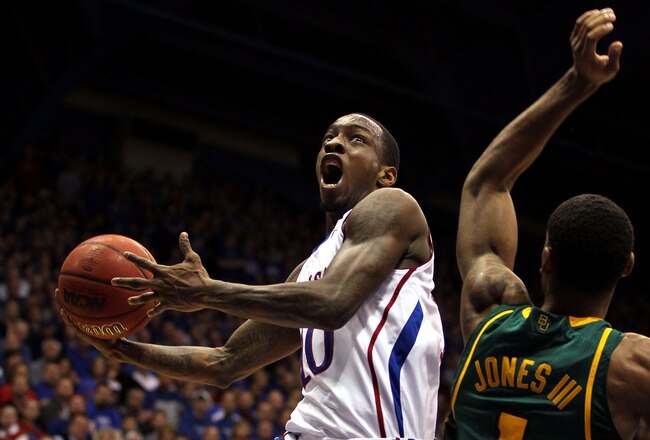 LAWRENCE, KS - JANUARY 16:  Tyshawn Taylor #10 of the Kansas Jayhawks shoots over Perry Jones III #1 of the Baylor Bears during the game on January 16, 2012 at Allen Fieldhouse in Lawrence, Kansas.  (Photo by Jamie Squire/Getty Images)