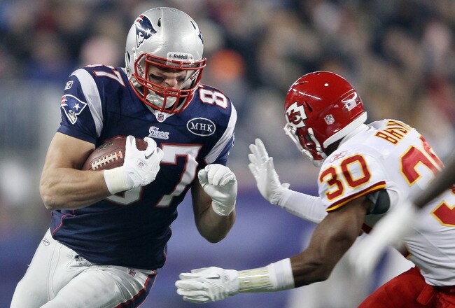 FOXBORO, MA - NOVEMBER 21:   Rob Gronkowski #87 of the New England Patriots carries the ball as  Jalil Brown #30 of the Kansas City Chiefs defends on November 21, 2011 at Gillette Stadium in Foxboro, Massachusetts.  (Photo by Elsa/Getty Images)