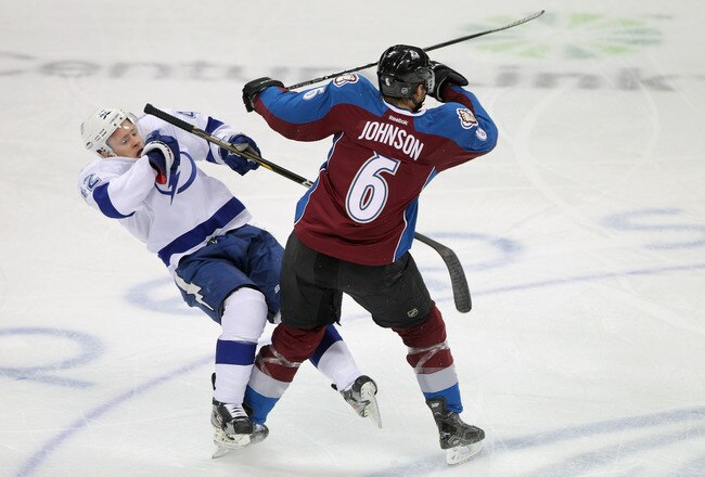 DENVER, CO - DECEMBER 23:  Erik Johnson #6 of the Colorado Avalanche delivers a hit to Dana Tyrell #42 of the Tampa Bay Lightning at the Pepsi Center on December 23, 2011 in Denver, Colorado.  (Photo by Doug Pensinger/Getty Images)