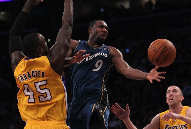 LOS ANGELES, CA - DECEMBER 07:  Gilbert Arenas #9 of the Washington Wizards passes the ball between Derrick Caracter #45 and Steve Blake #5 of the Los Angeles Lakers in the second half at Staples Center on December 7, 2010 in Los Angeles, California. The Lakers defeated the Wizards 115-108. NOTE TO USER: User expressly acknowledges and agrees that, by downloading and or using this photograph, User is consenting to the terms and conditions of the Getty Images License Agreement.  (Photo by Jeff Gross/Getty Images)