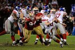 SAN FRANCISCO, CA - JANUARY 22:  Eli Manning #10 of the New York Giants attempts to avoid pressure from Justin Smith #94 of the San Francisco 49ers during the NFC Championship Game at Candlestick Park on January 22, 2012 in San Francisco, California.  (Photo by Thearon W. Henderson/Getty Images)