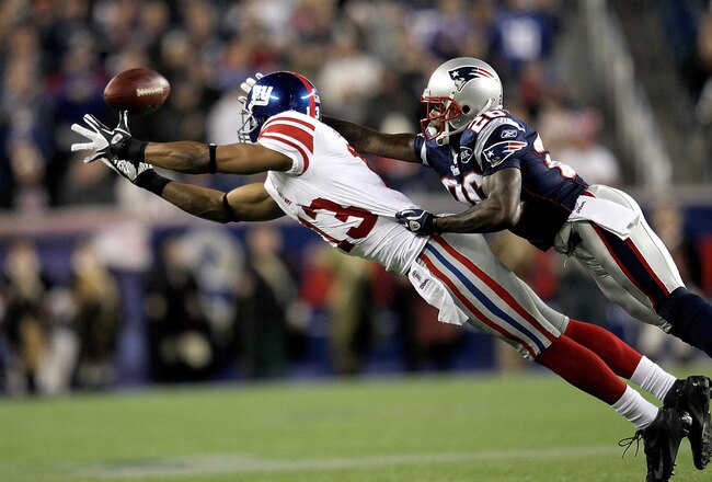 FOXBORO, MA - NOVEMBER 6:   Ramses Barden #13 of the New York Giants comes up short against the defense of  Phillip Adams #26 of the New England Patriots at Gillette Stadium in the second half on November 6, 2011 in Foxboro, Massachusetts. (Photo by Jim Rogash/Getty Images)