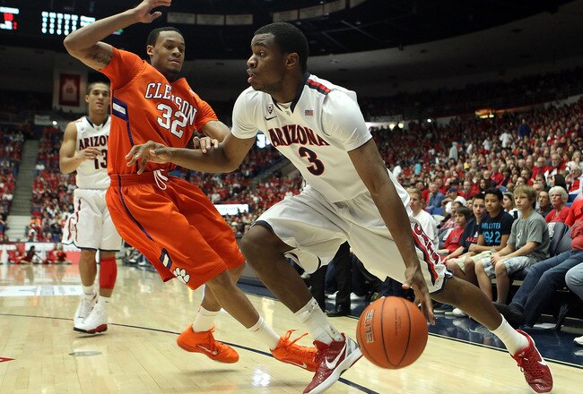 TUCSON, AZ - DECEMBER 10:  Kevin Parrom #3 of the Arizona Wildcats handles the ball under pressure from K.J. McDaniels #32 of the Clemson Tigers during the first half of the college basketball game at McKale Center on December 10, 2011 in Tucson, Arizona. The Wildcats defeated the Tigers 63-47.  (Photo by Christian Petersen/Getty Images)