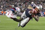 FOXBORO, MA - NOVEMBER 6:   Aaron Hernandez #81 of the New England Patriots scores against the defense of  Kenny Phillips #21 of the New York Giants at Gillette Stadium in the second half on November 6, 2011 in Foxboro, Massachusetts. (Photo by Jim Rogash/Getty Images)